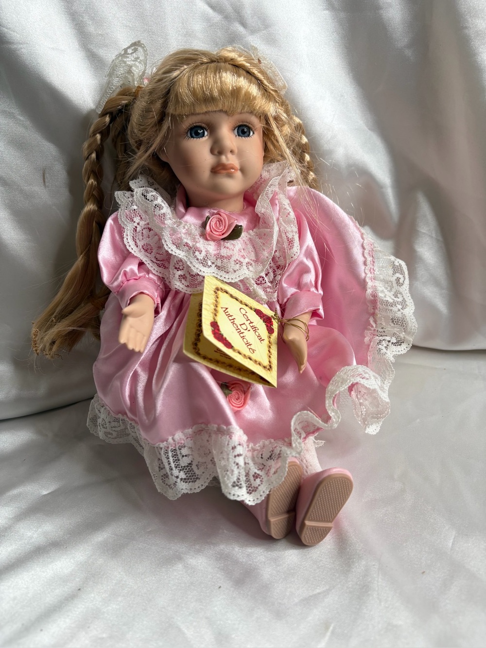 DanDee Collector's Choice porcelain doll w/ a pink satin dress with lace trim